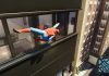 Spiderman crawling across building windows in Marvel's Spider-Man 2.