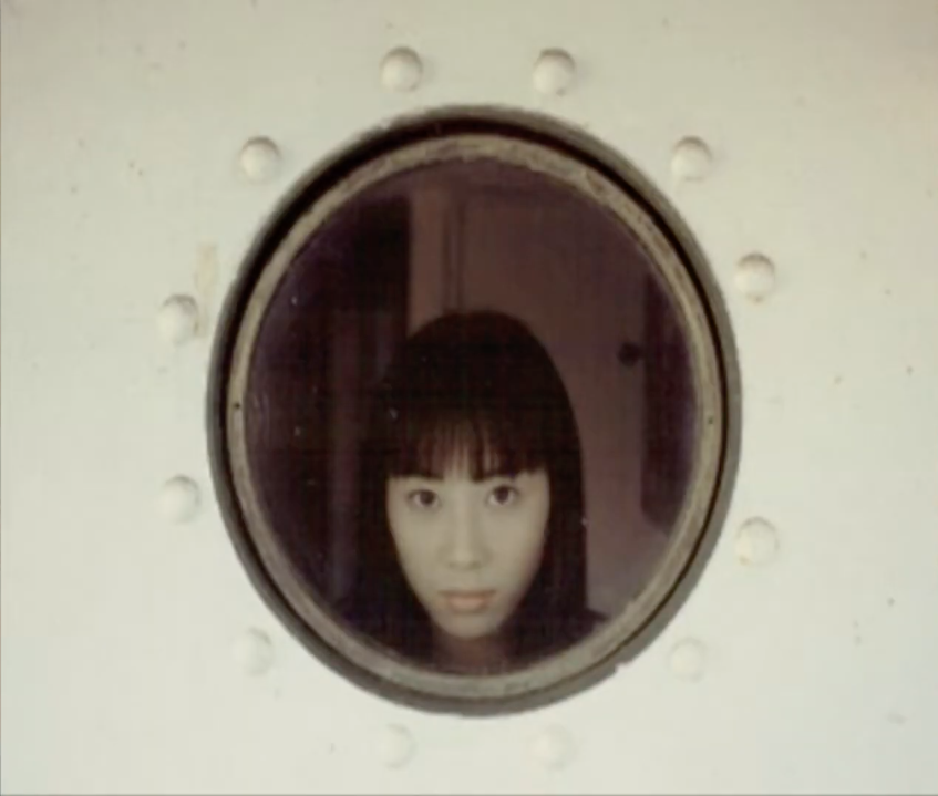Rin Ozawa looks out of a ship porthole in Suzuki Bakuhatsu