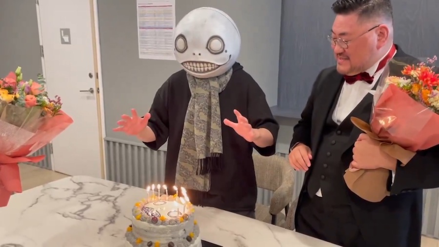 Yoko Taro tries to blow out birthday cake candles